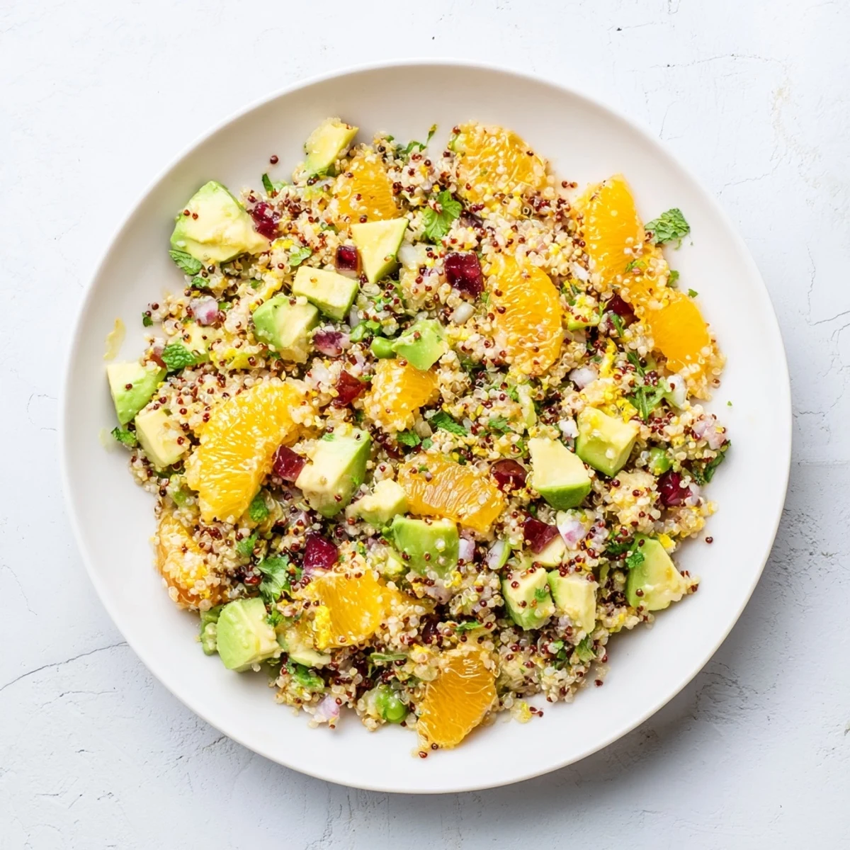 A close-up of a Fresh Citrus & Avocado Quinoa Bowl, showcasing vibrant colors and fresh herbs.