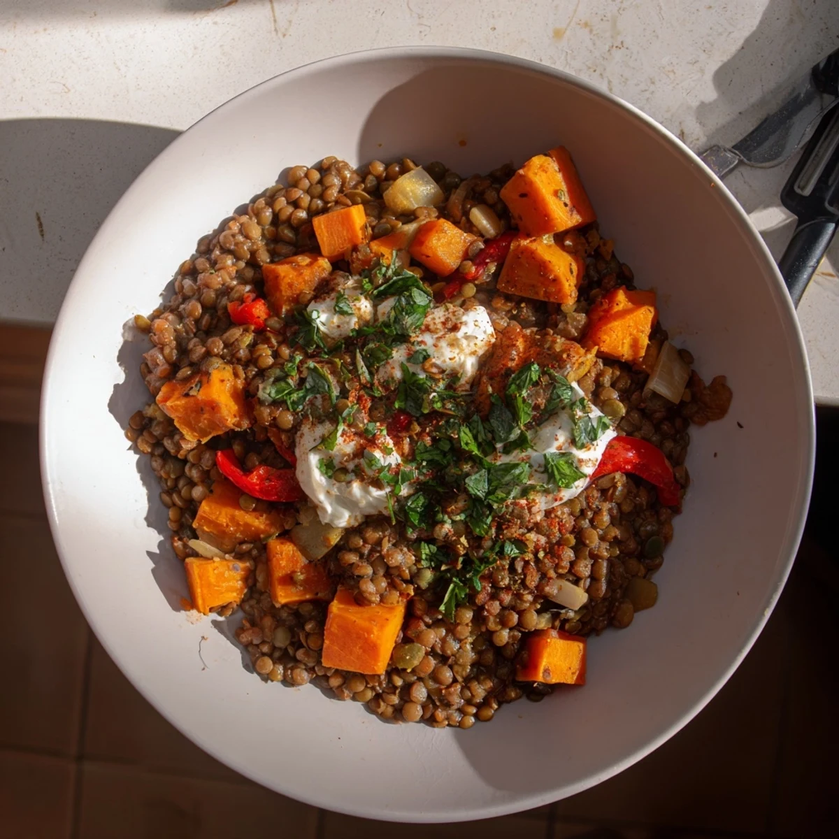 Steaming bowl of Wheat-Warm Hearty Lentil Curry, a rustic and flavorful vegetarian meal.