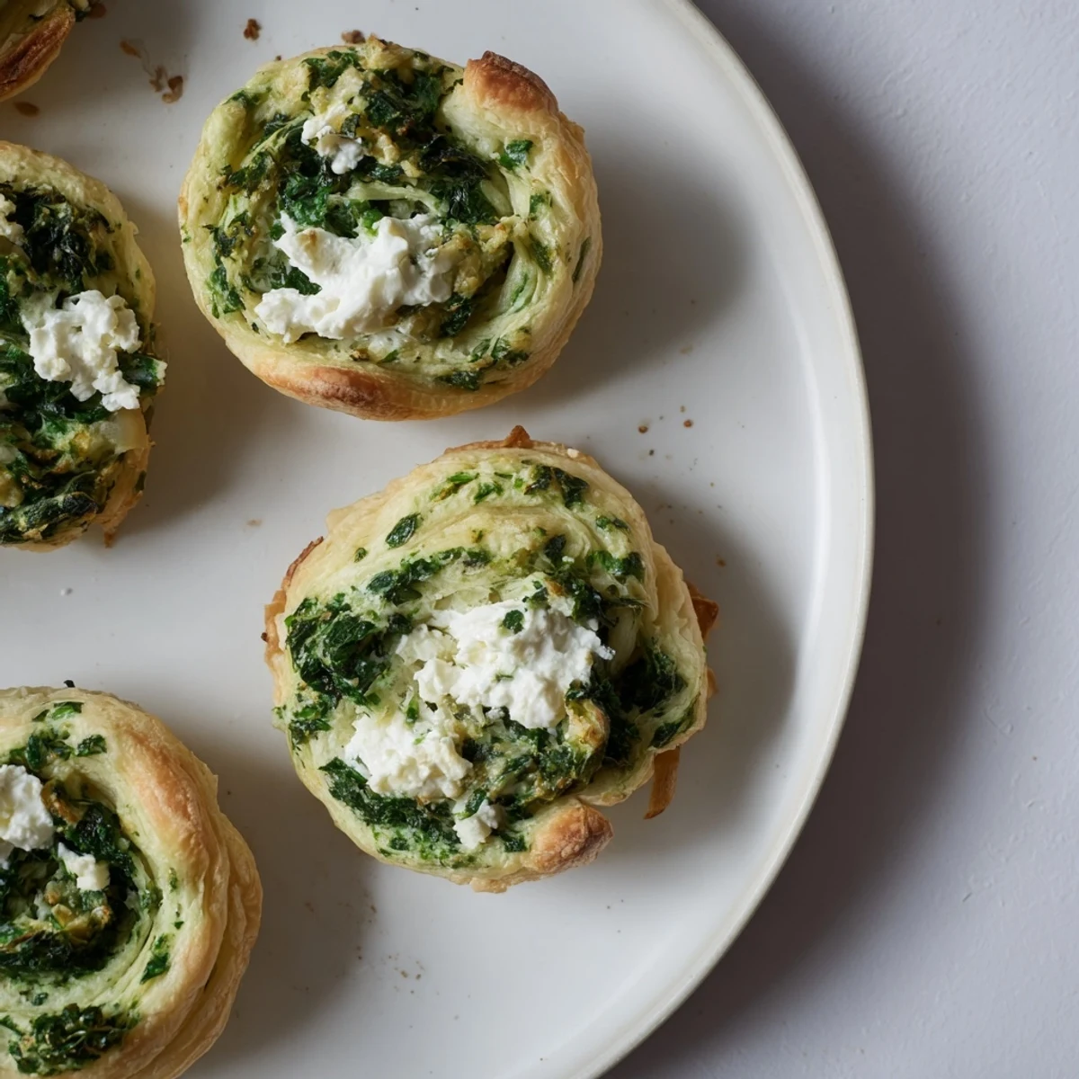 Golden Savory Spinach Feta Pinwheel Spirals, flaky and filled with creamy spinach and salty feta.