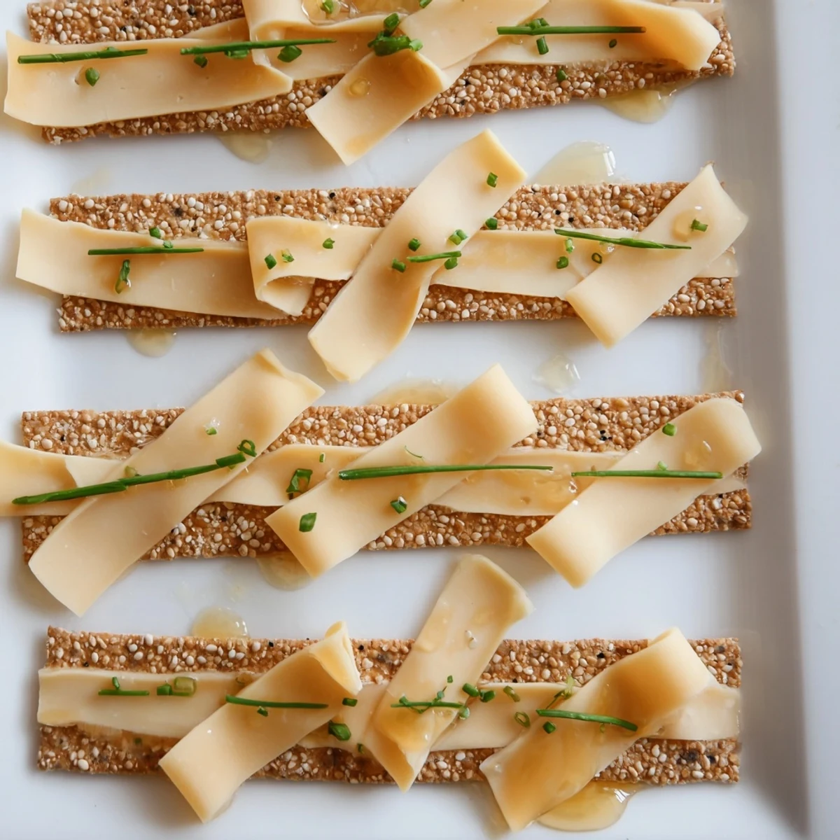 The Garden Gate Lattice: a stunning vegetarian appetizer with woven cheese and cracker strips, drizzled with honey.