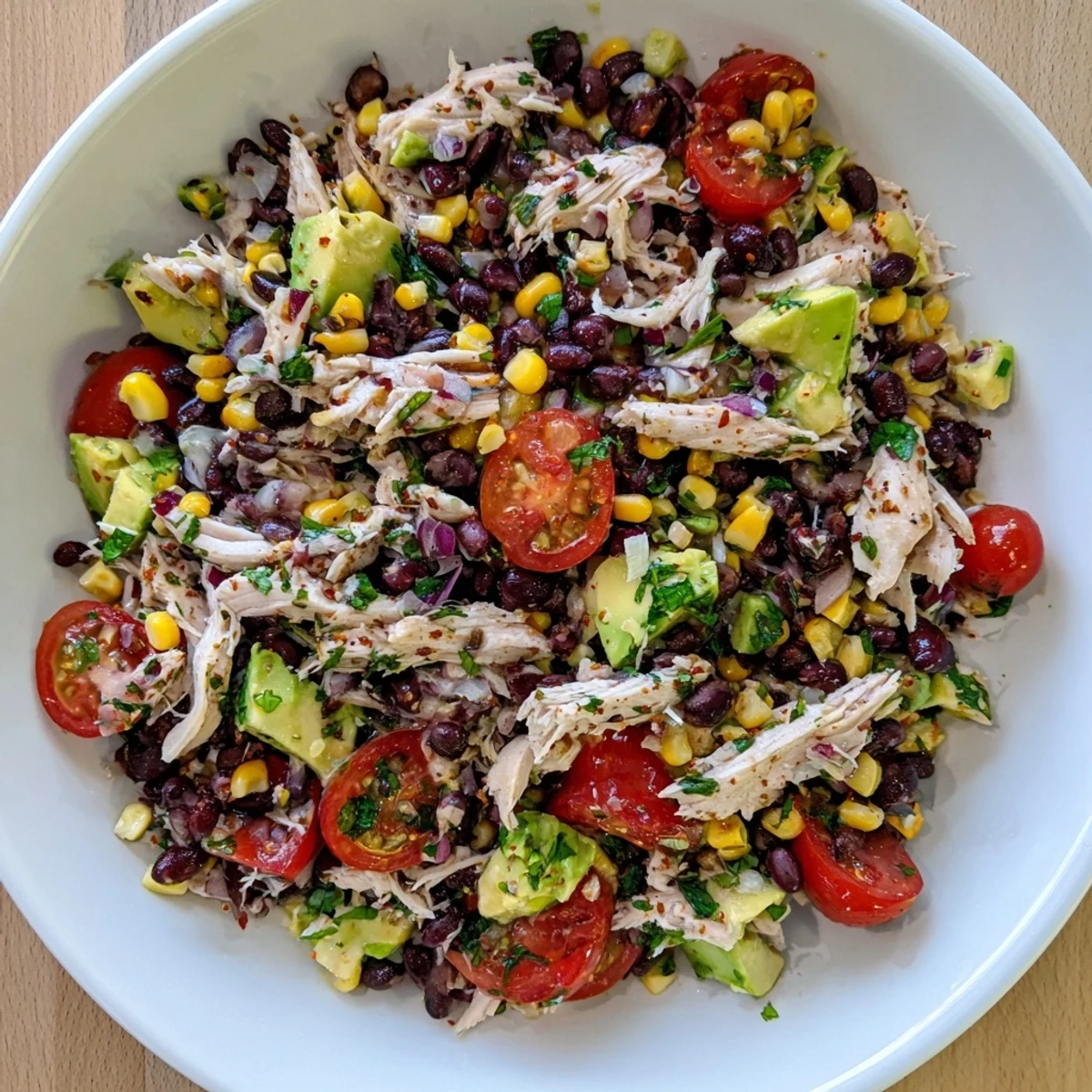 A bright and colorful bowl of Dense Southwestern Bean Salad, perfect for a summer gathering.