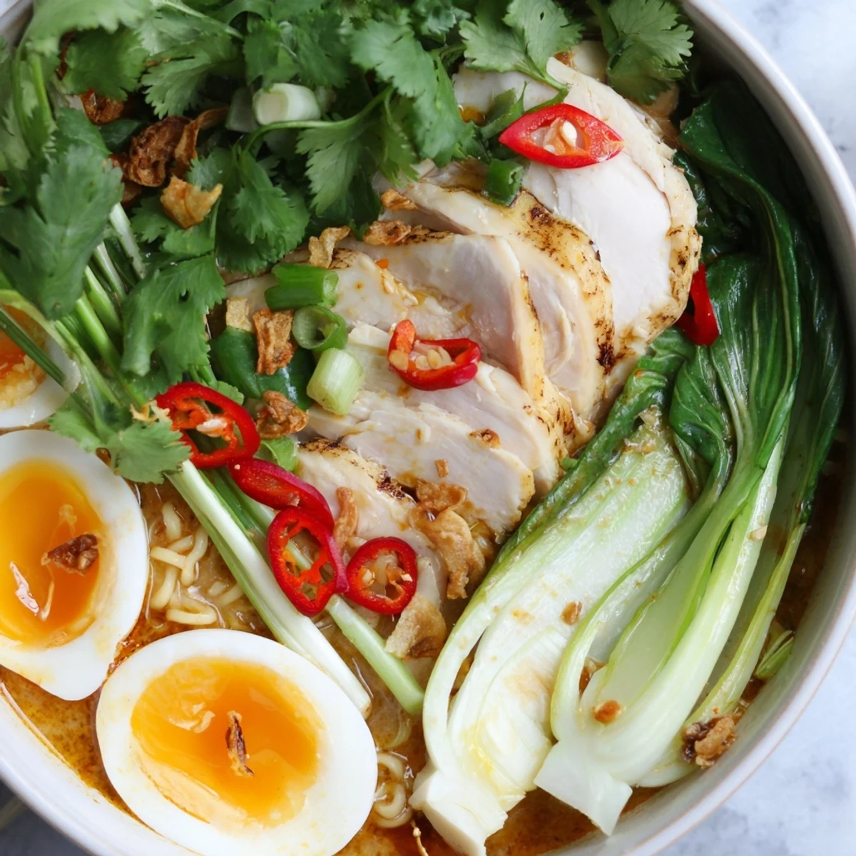 Served Thai Miso Ramen Bowl with noodles, chili slices, and lime wedges for bright flavor.