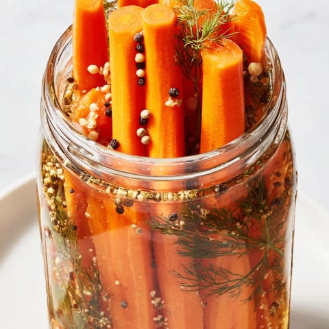 Vibrant Quick Pickled Carrot Spears offering a delightful crunch, ready to enjoy as a flavorful snack.