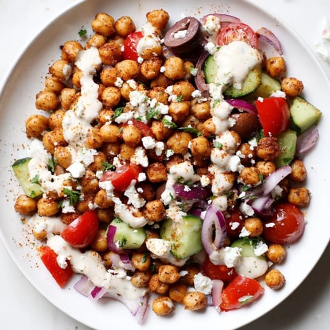 Mediterranean Chickpea Bowl bursting with color: Roasted chickpeas and fresh veggies with creamy tahini dressing.