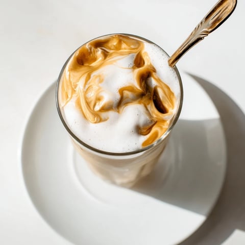 Fluffy Starbucks Cold Foam drizzled over iced coffee, offering a cool, creamy texture and perfect sweetness.