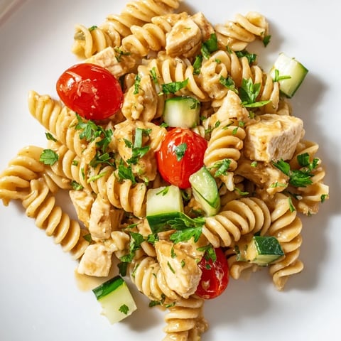 Creamy honey mustard dressing coats tender diced chicken and spiral pasta, mixed with crisp veggies for a vibrant salad.