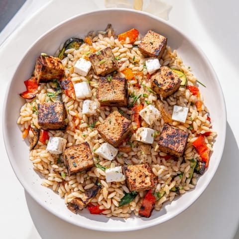 This flavorful Mediterranean Lamb and Orzo Supper shows off a hearty one-pot meal, steaming hot.