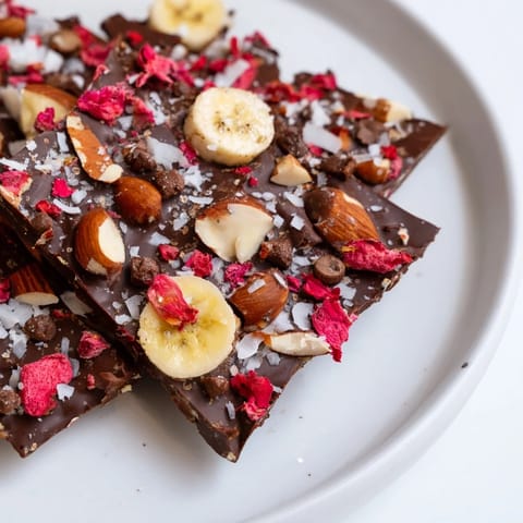 Close-up of Chocolate Banana Bark, showing the chocolate layer over sliced bananas and nuts.