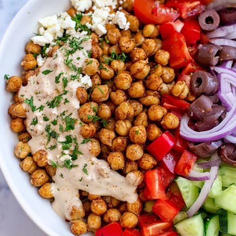 A close-up of a flavorful Mediterranean Chickpea Bowl, showcasing the beautifully seasoned roasted chickpeas.