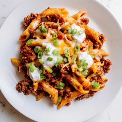 Flavorful one-pot taco pasta, with melted cheese and fresh herbs, a comforting family favorite.