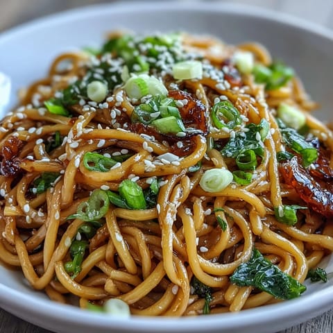 Tender noodles tossed with fresh ginger, scallions, and a sweet-savory soy glaze in this easy Asian-inspired recipe.