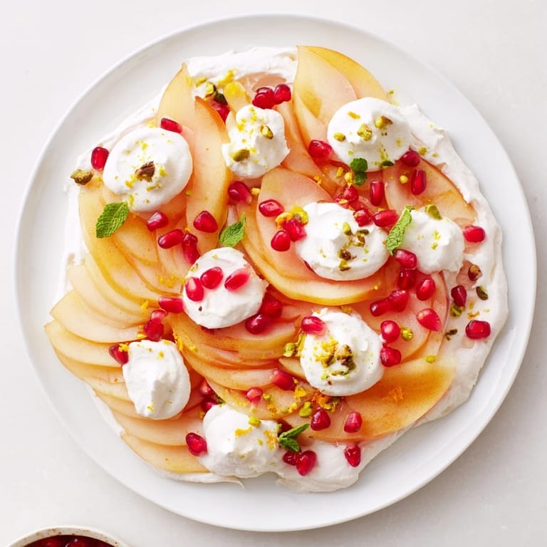 This plated Winter Fruit Snowscape, featuring persimmons, pears, and cream, presents a delightful, light dessert.