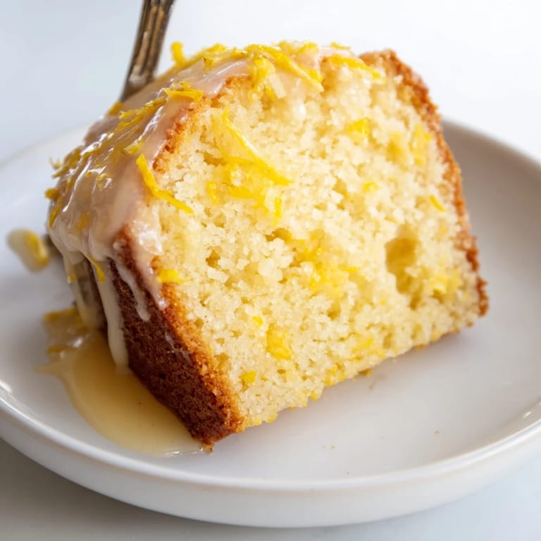 Freshly baked Lemon Yogurt Cake, showing a golden crust and a moist, airy texture.